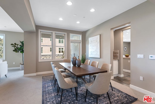 dining room featuring carpet and a healthy amount of sunlight