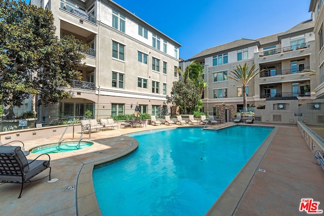 view of pool with a community hot tub and a patio