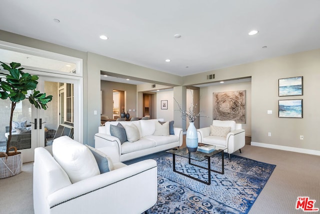 living room featuring french doors and carpet