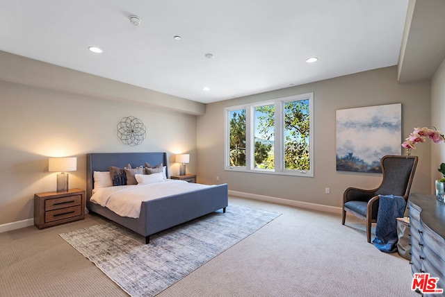 bedroom featuring light carpet