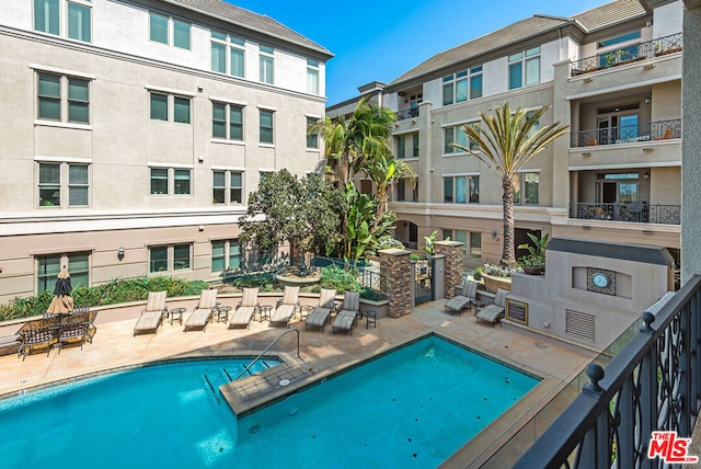 view of swimming pool featuring a patio area