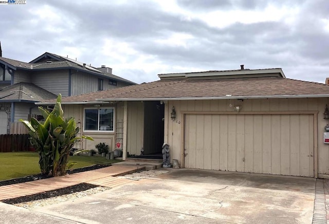 view of front of property with a garage and a front lawn