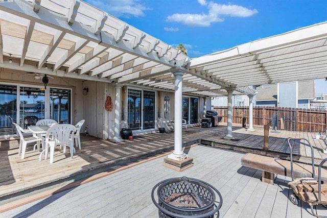 deck with a fire pit and a pergola