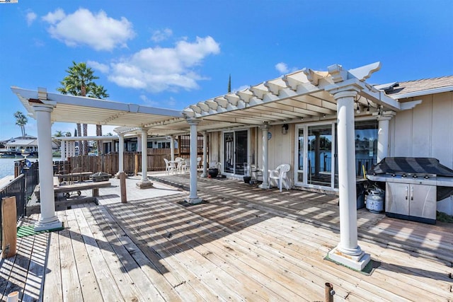 deck featuring a grill and a pergola