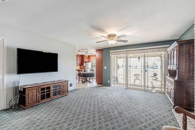 carpeted living room with ceiling fan