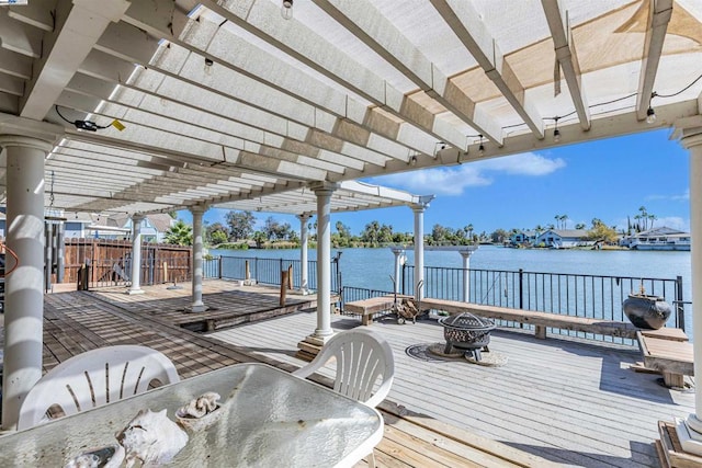 deck with a pergola and a water view