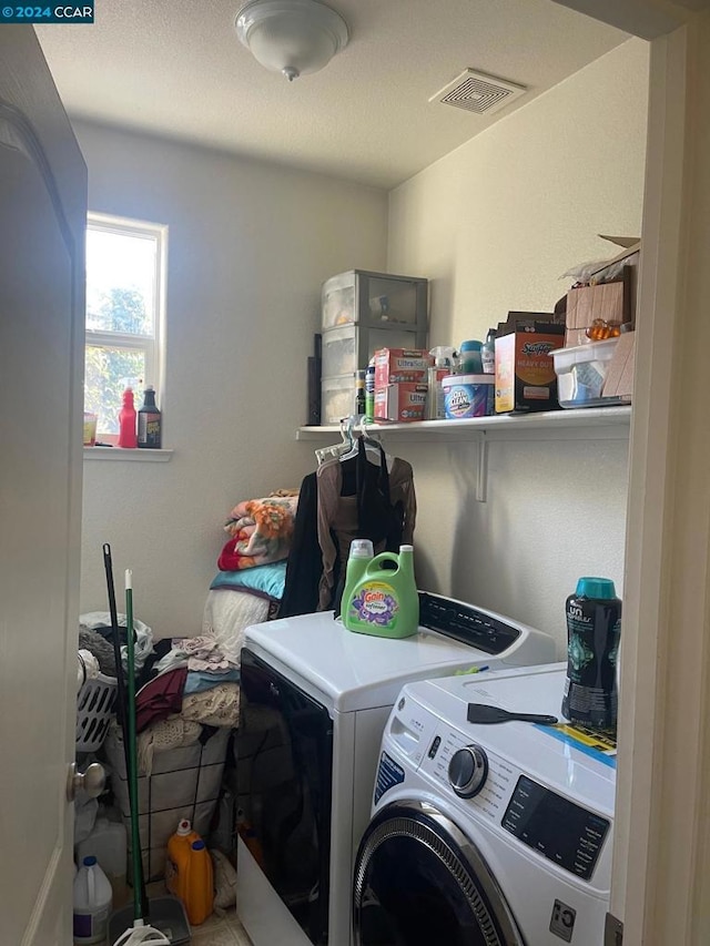 clothes washing area with washer and clothes dryer