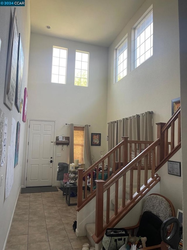 tiled entryway with a high ceiling