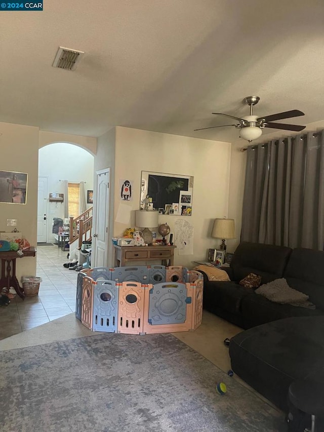 tiled living room featuring ceiling fan