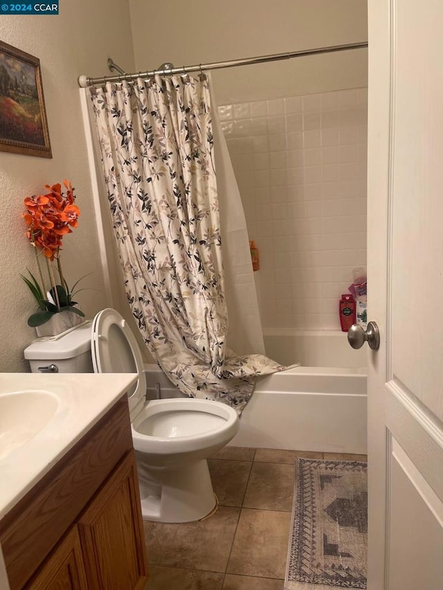 full bathroom with shower / tub combo, tile patterned flooring, vanity, and toilet