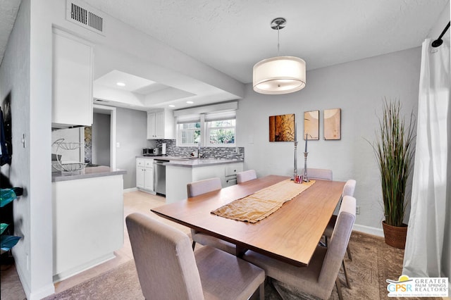 dining space featuring a tray ceiling