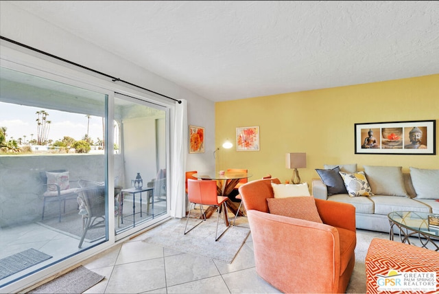 living room with a textured ceiling and light tile patterned floors