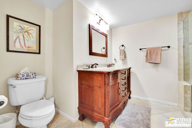 bathroom featuring tile patterned floors, a shower, vanity, and toilet