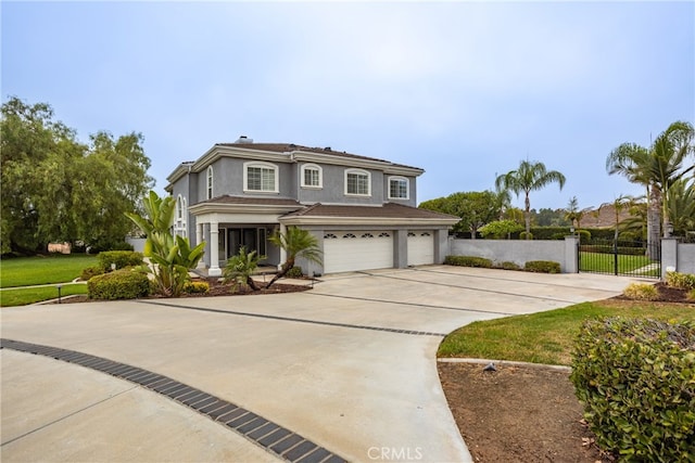 view of property featuring a garage and a front lawn