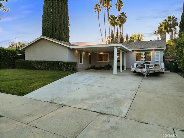 single story home with a carport and a front yard