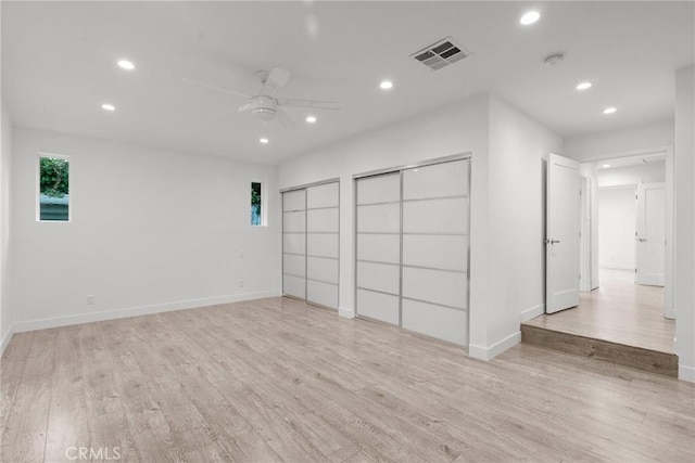 spare room featuring light hardwood / wood-style floors and ceiling fan