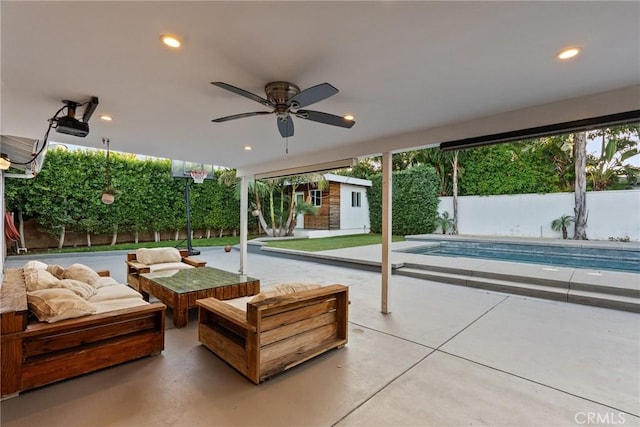 view of patio with an outdoor living space and an outbuilding