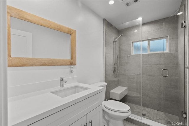 bathroom with vanity, toilet, and walk in shower