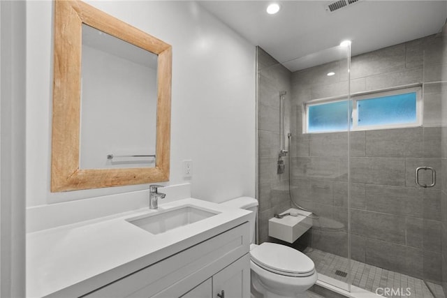 bathroom with vanity, toilet, and walk in shower