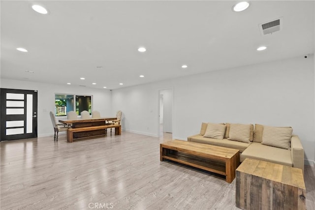 living room with light hardwood / wood-style flooring