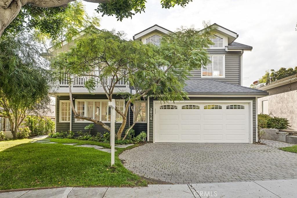 view of front of property with a front yard and a garage