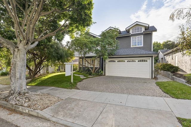 view of front of home featuring a garage and a front yard