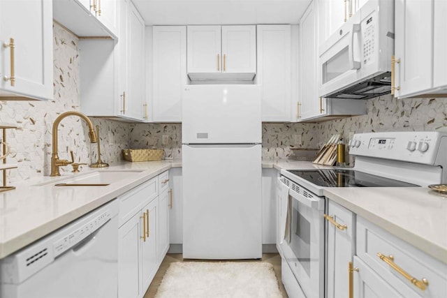 kitchen featuring white appliances, sink, tasteful backsplash, and white cabinets