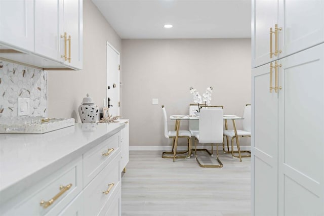 dining space with light hardwood / wood-style flooring