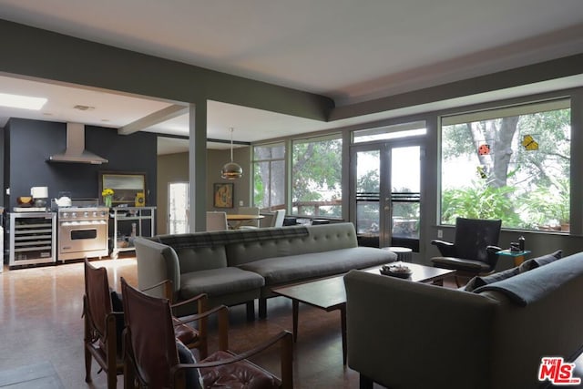 living room with beverage cooler and concrete flooring