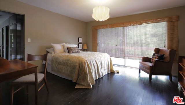 bedroom with access to outside and wood-type flooring