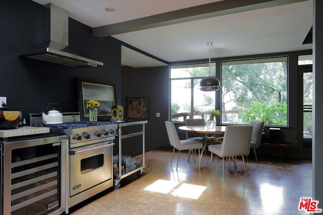 kitchen with beverage cooler, stainless steel range, and wall chimney range hood