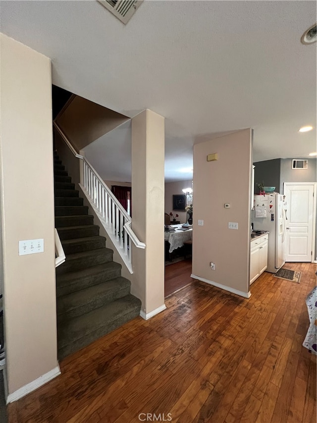 staircase featuring hardwood / wood-style flooring