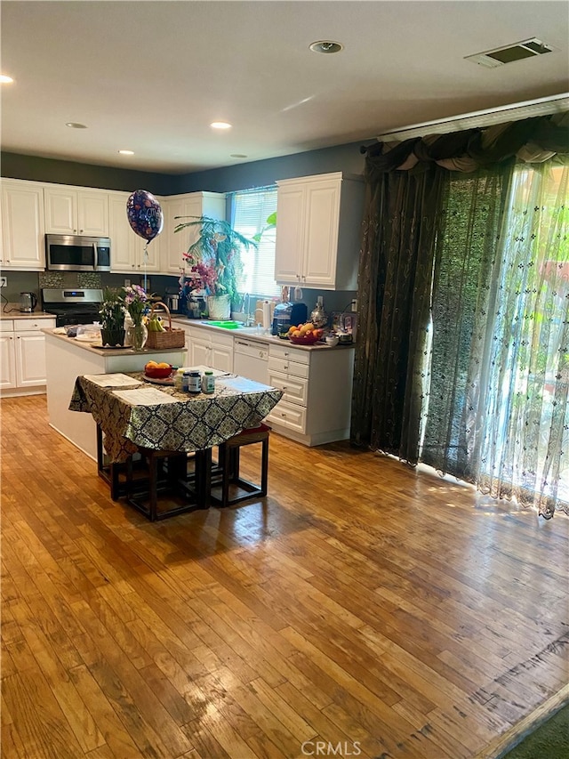 dining area with light hardwood / wood-style floors