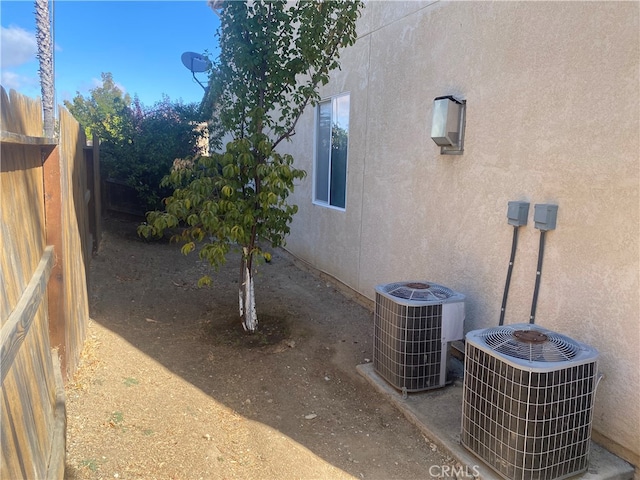 view of side of home featuring central AC unit