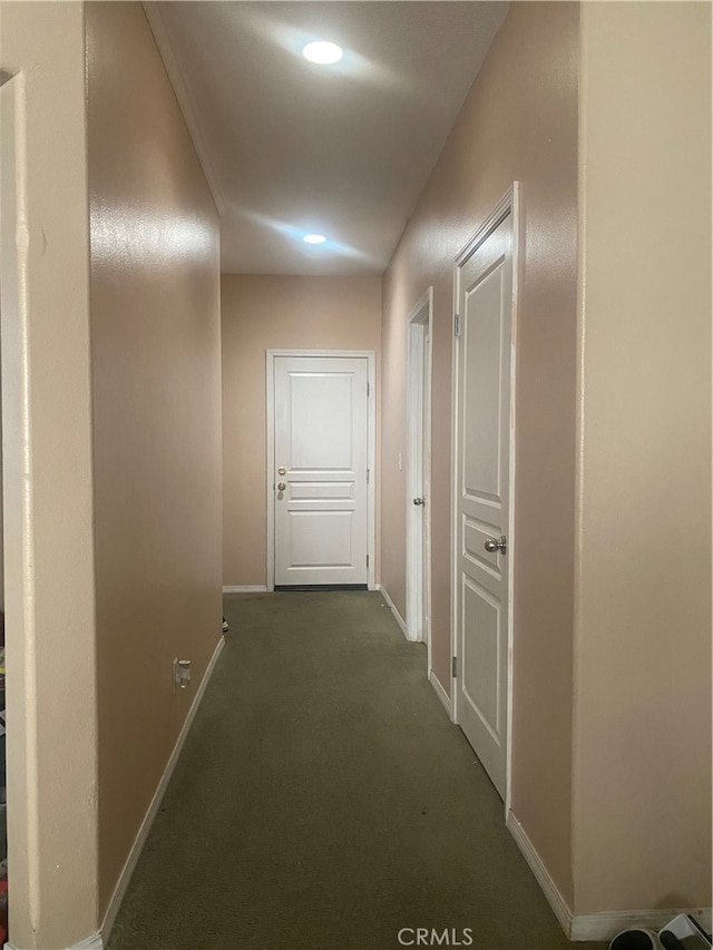 hallway with dark colored carpet