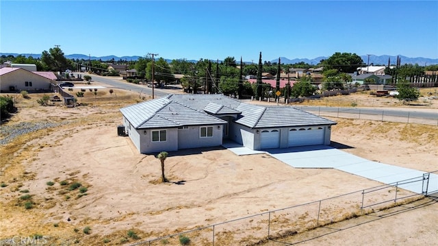 view of front of home featuring a mountain view and a garage