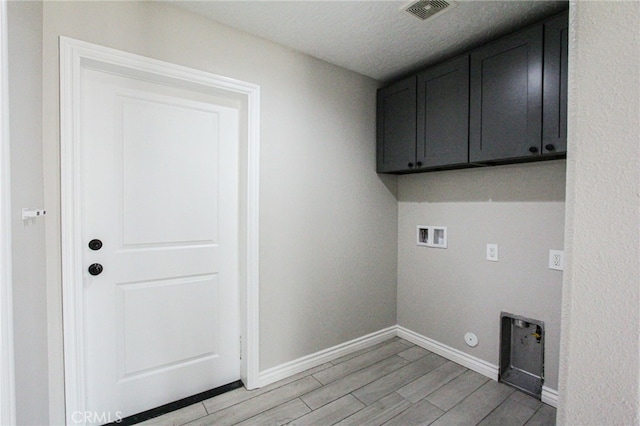 laundry area with hookup for a gas dryer, cabinets, hookup for a washing machine, light wood-type flooring, and electric dryer hookup