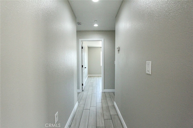 hallway with light wood-type flooring