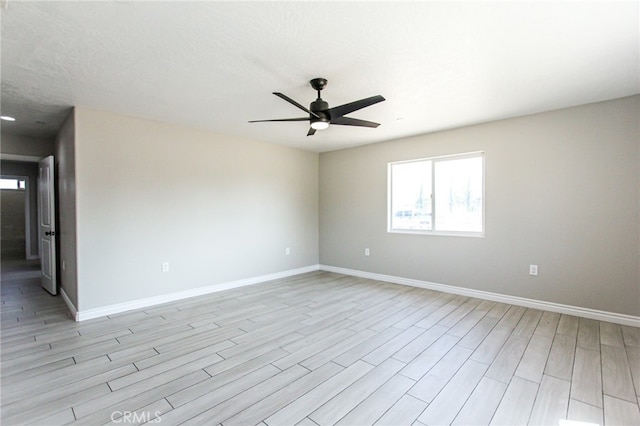 spare room featuring light hardwood / wood-style flooring and ceiling fan