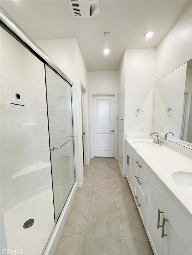 bathroom featuring walk in shower, vanity, and tile patterned floors