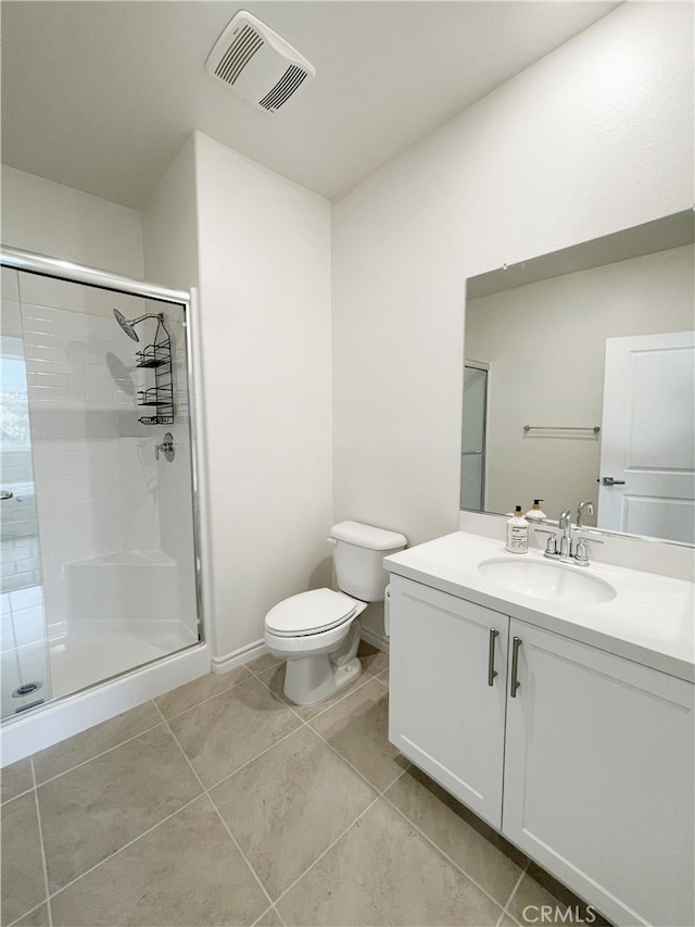 bathroom with tile patterned flooring, vanity, toilet, and an enclosed shower