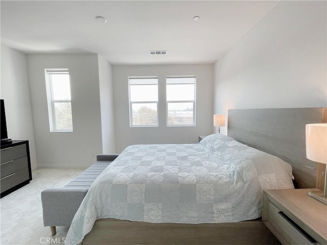 carpeted bedroom featuring multiple windows