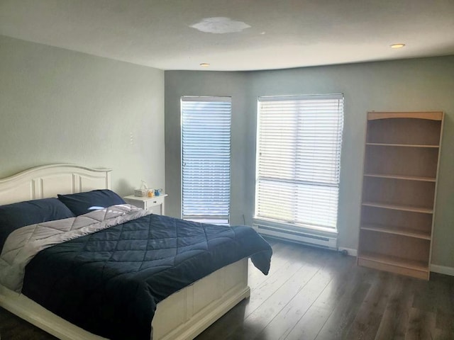 bedroom with dark hardwood / wood-style floors