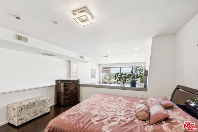 bedroom with dark hardwood / wood-style flooring