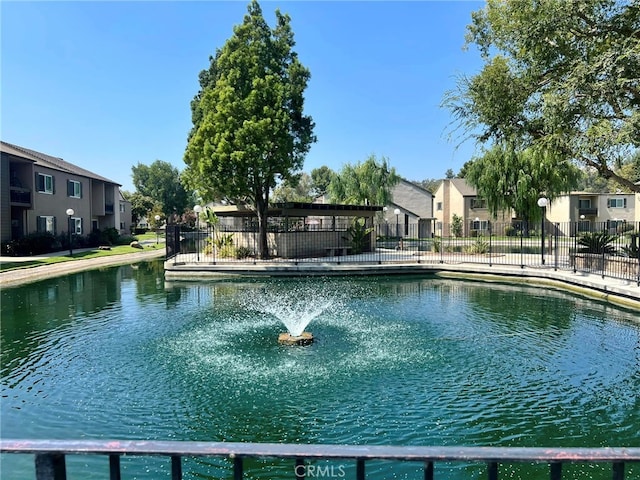 view of swimming pool with a water view