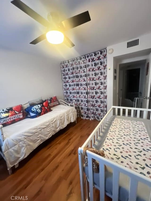 bedroom featuring hardwood / wood-style flooring and ceiling fan