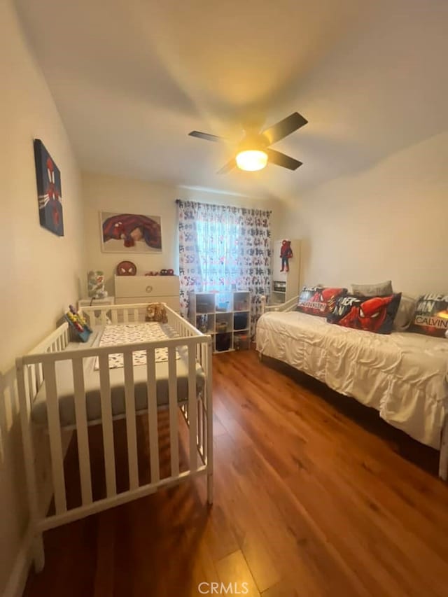 bedroom featuring hardwood / wood-style floors and ceiling fan