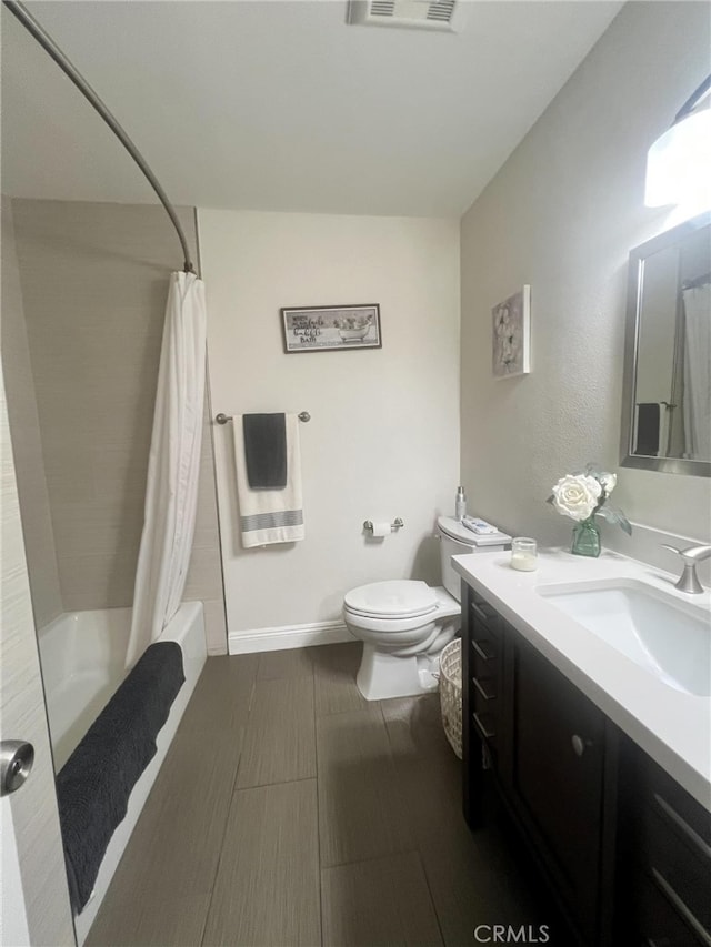 full bathroom featuring vanity, shower / bath combo, and toilet