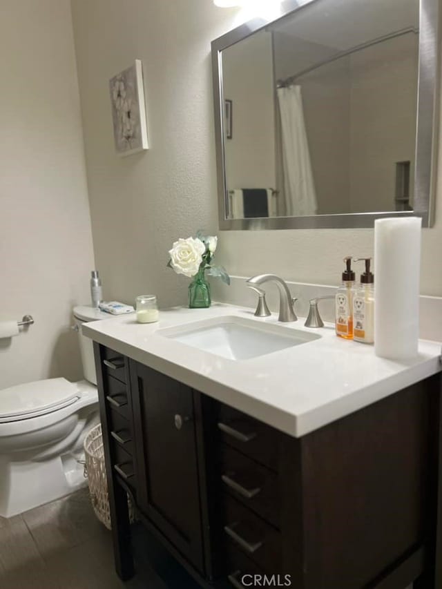 bathroom with tile patterned floors, vanity, and toilet