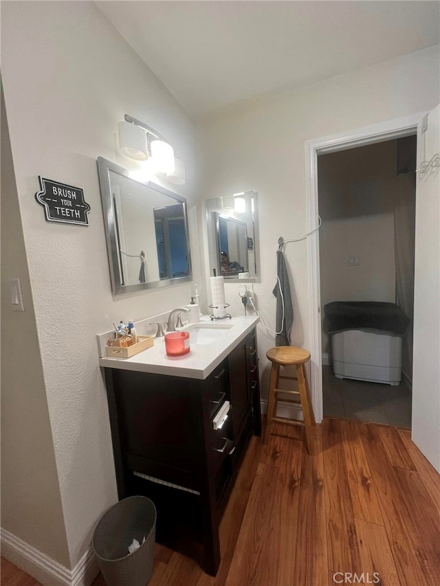 bathroom with hardwood / wood-style floors and vanity